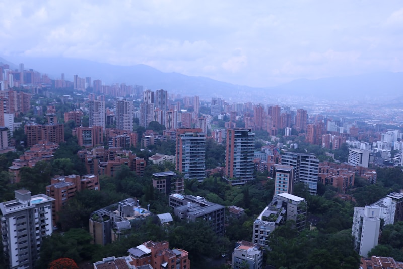 Tandem paragliding Medellin with city view below